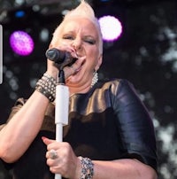 a woman singing into a microphone at a concert