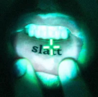 a person's mouth with the word slatt written on it