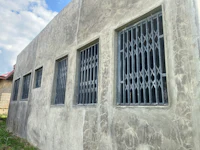 a concrete building with bars on the windows