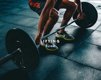 a man lifting a barbell in a gym