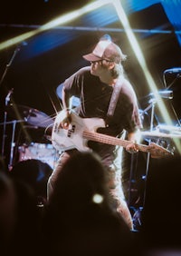a man playing a guitar on stage