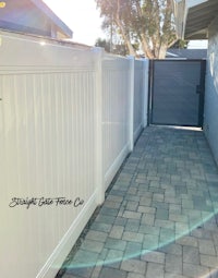 a white picket fence in a backyard