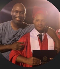 two men posing for a photo with their diplomas