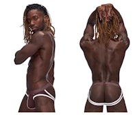 a man with dreadlocks is posing in a thong
