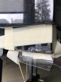 a piece of tape is taped to the side of a car