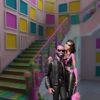 a man and woman standing in front of a colorful staircase