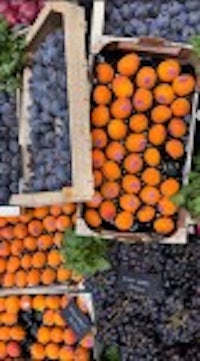 a variety of fruits and vegetables are on display at a market