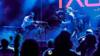 a group of people on stage at a concert