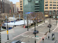 a city street with a lot of people walking around