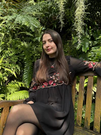 a woman sitting on a wooden bench