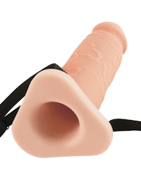 a pink dildo with a black strap