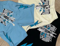 a pair of blue and black shorts with lightning bolts on them