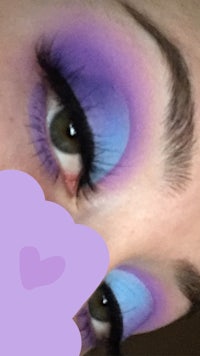 a woman with purple and blue eye makeup
