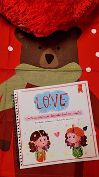 a teddy bear with a book on it