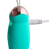 a teal electric toothbrush with a pink cord attached to it
