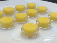 lemon lip balm jars on a white plate