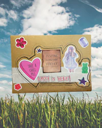 a box with stickers on it sitting in a grassy field