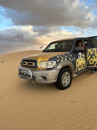 a truck is parked in the sand