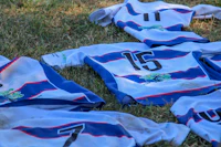 a bunch of soccer jerseys laying on the ground