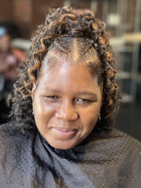a woman with curly hair in a salon