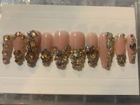a set of nails with a lot of crystals on them