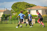 a group of young men playing soccer on a green field