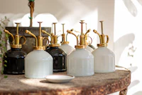 a group of white and black vases on a table