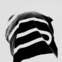 a black and white photo of a person wearing a beanie