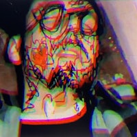 an image of a man with glasses and a beard