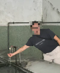 a man standing next to a water fountain in a building