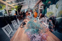 a group of people sitting at a table in a restaurant