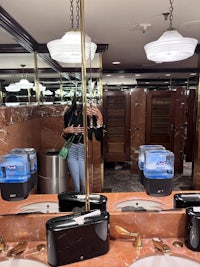 a woman is taking a picture of herself in a bathroom