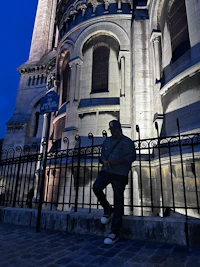 a man standing on a railing next to a building