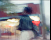 a blurry image of a person walking down the street