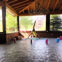 a woman doing yoga on a concrete floor