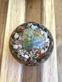 a stone sphere on a wooden table