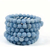 a stack of blue jade beads on a white background