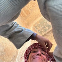 a woman is getting her hair braided in an ancient egyptian temple