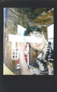 a photo of a man with a polaroid camera