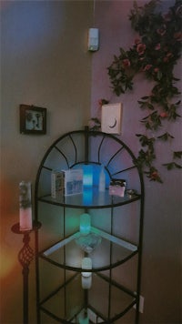 a room with a shelf and a lamp in it