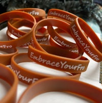 a group of orange wristbands with the words embrace your fp