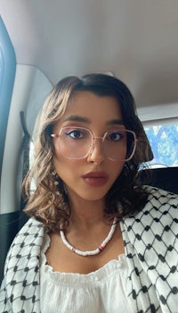 a woman wearing glasses in a car
