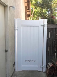 a white wooden gate in a backyard