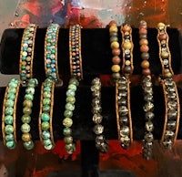 a display of bracelets with different colored stones