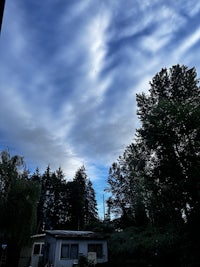 a cloudy sky with a house in the background