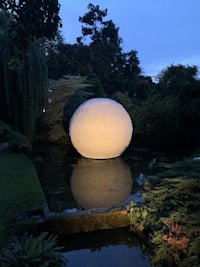 a large white ball in the middle of a pond