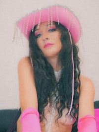 a woman wearing a pink cowboy hat