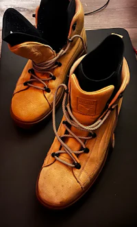 a pair of yellow sneakers sitting on a table