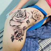 a woman with a tattoo of roses on her thigh