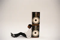 a person sitting on top of speakers